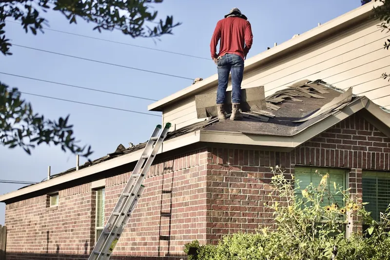 Professional roofer working on a residential roof in Minnick